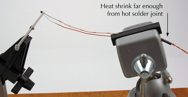 Intial location of small diameter heat shrink from away the solder joint