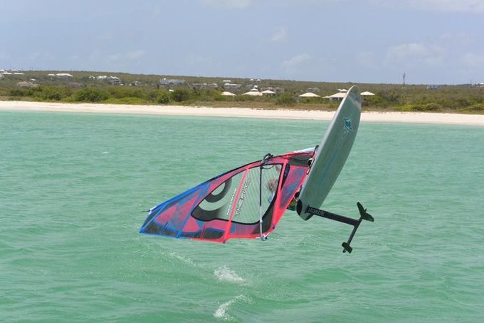 Hydrofoiling windsurfer jumping out of the water